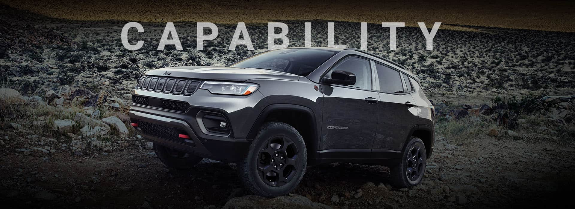 A 2024 Jeep Compass Trailhawk crawling over large and small rocks and stones off-road. Capability.