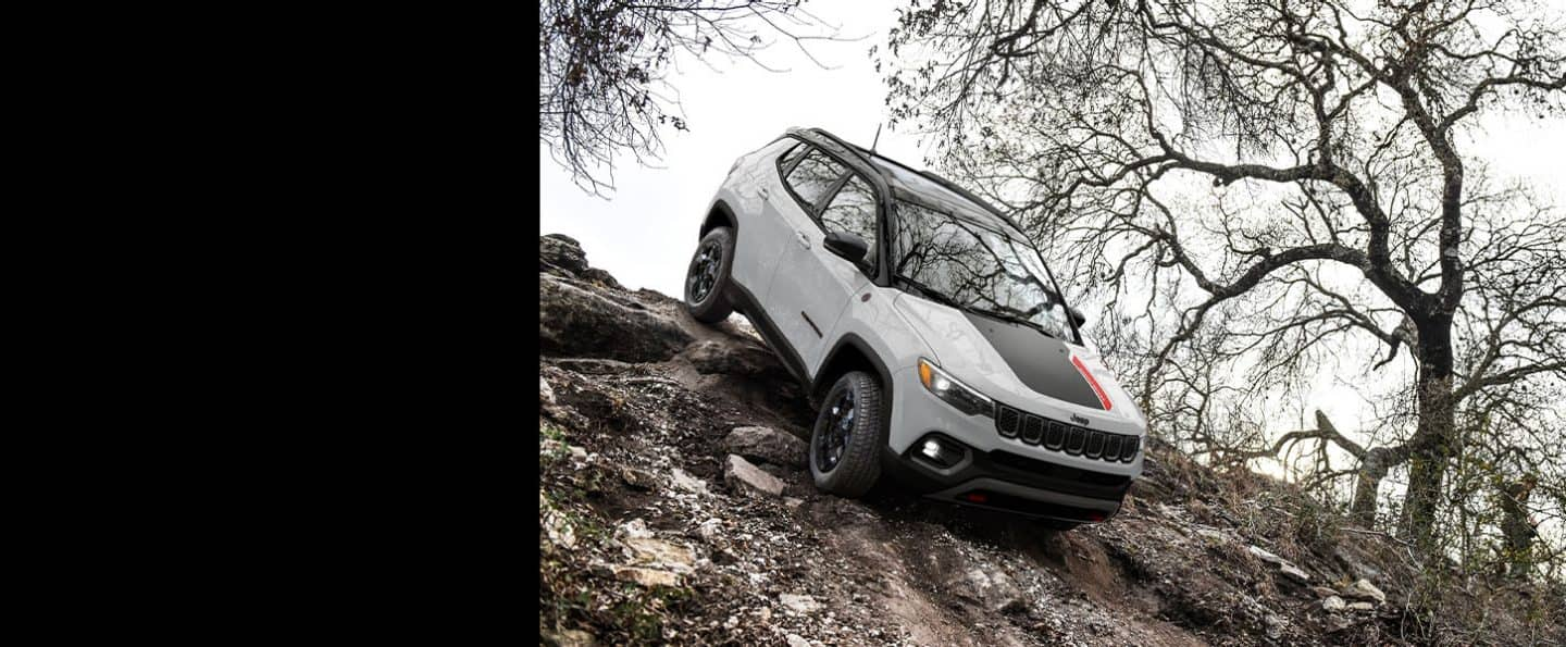 A 2024 Jeep Compass Trailhawk descending a very steep hill off-road.